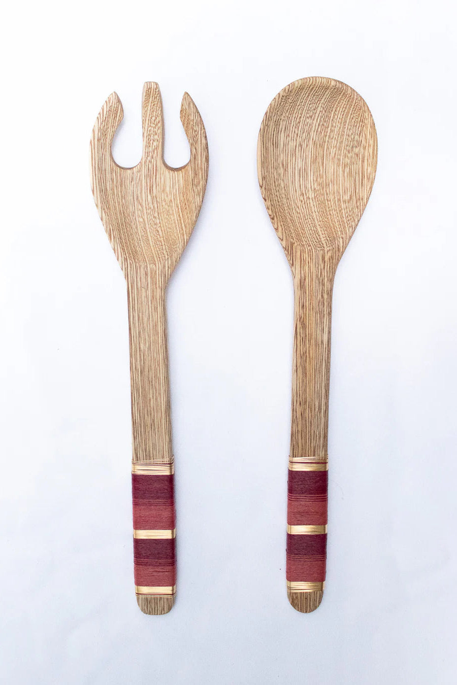 Wooden fork and spoon set with purple and gold accents on a white background