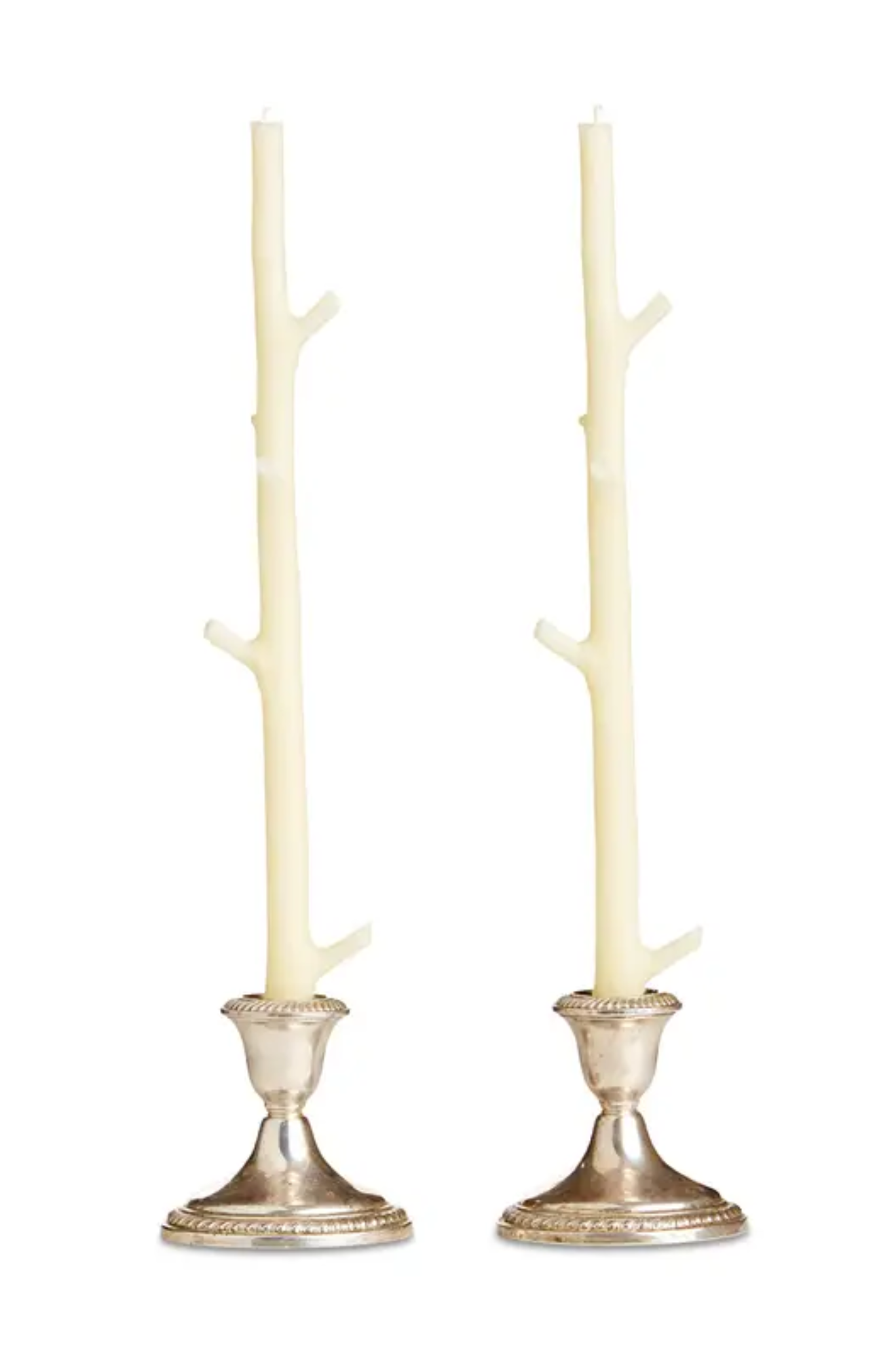 Two white branch-like candle tapers with silver bases on a white background
