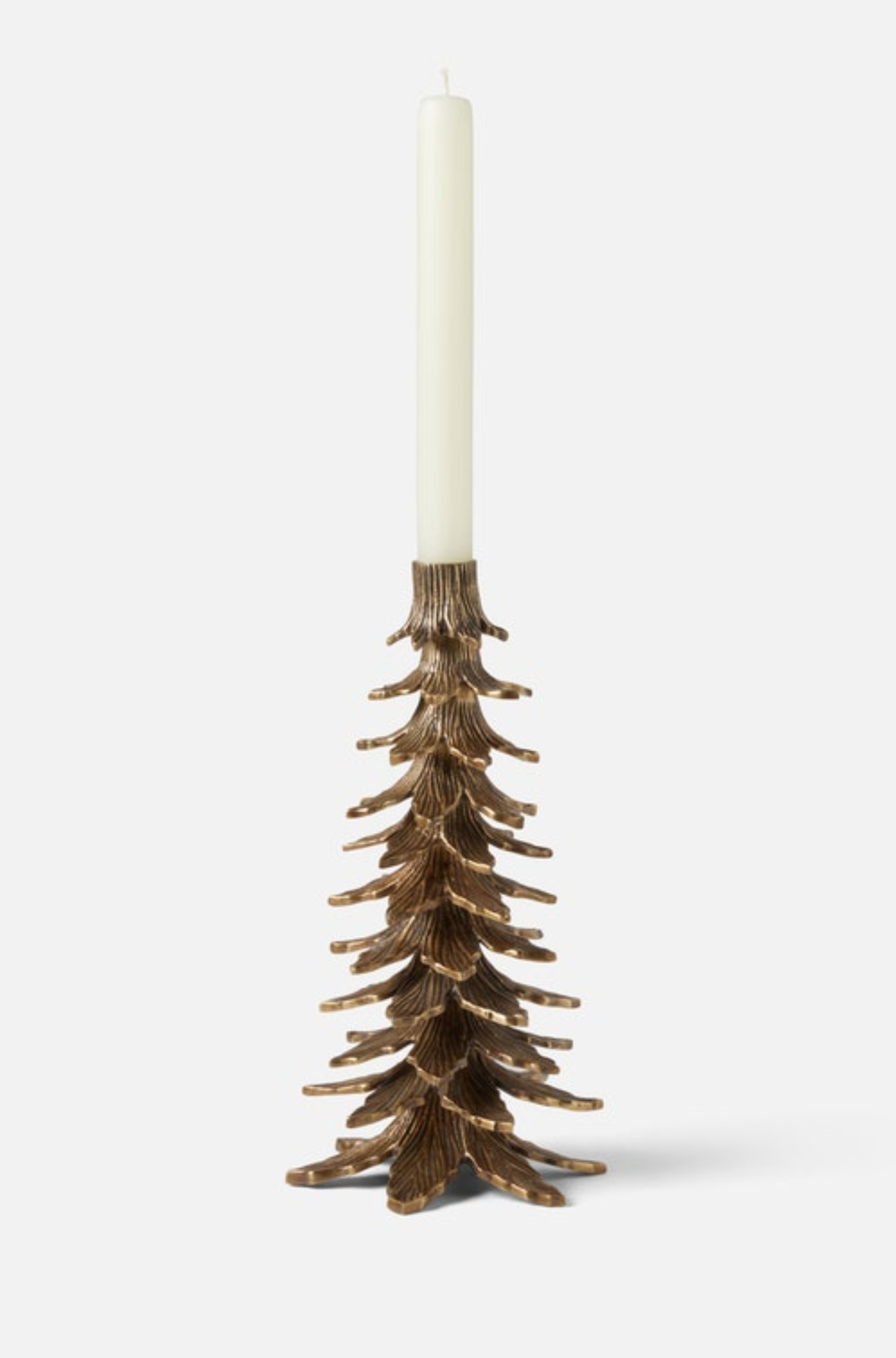 Decorative candle holder shaped like a tree with a white candle on a white background