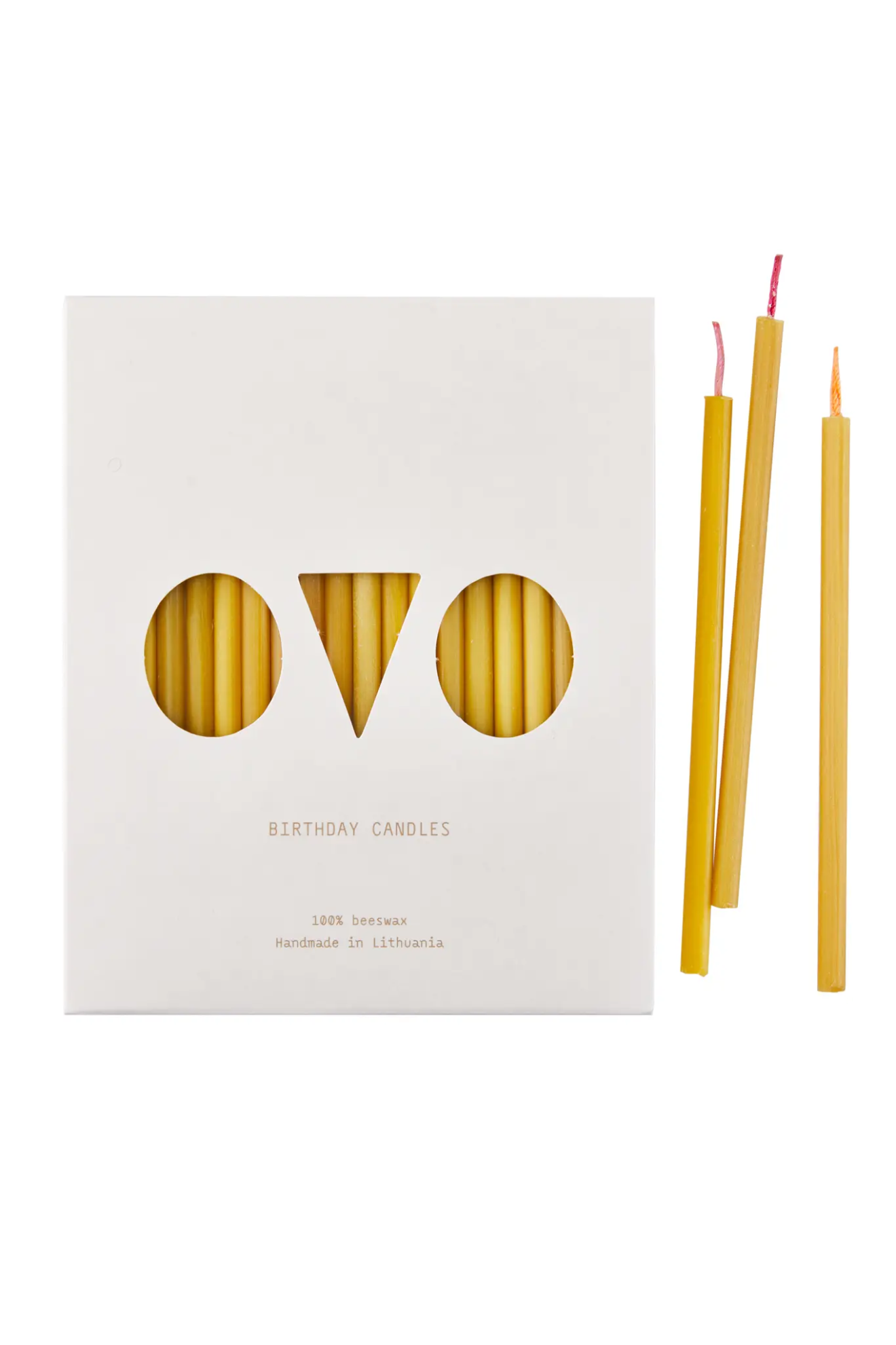 Beeswax candles with packaging on a white background