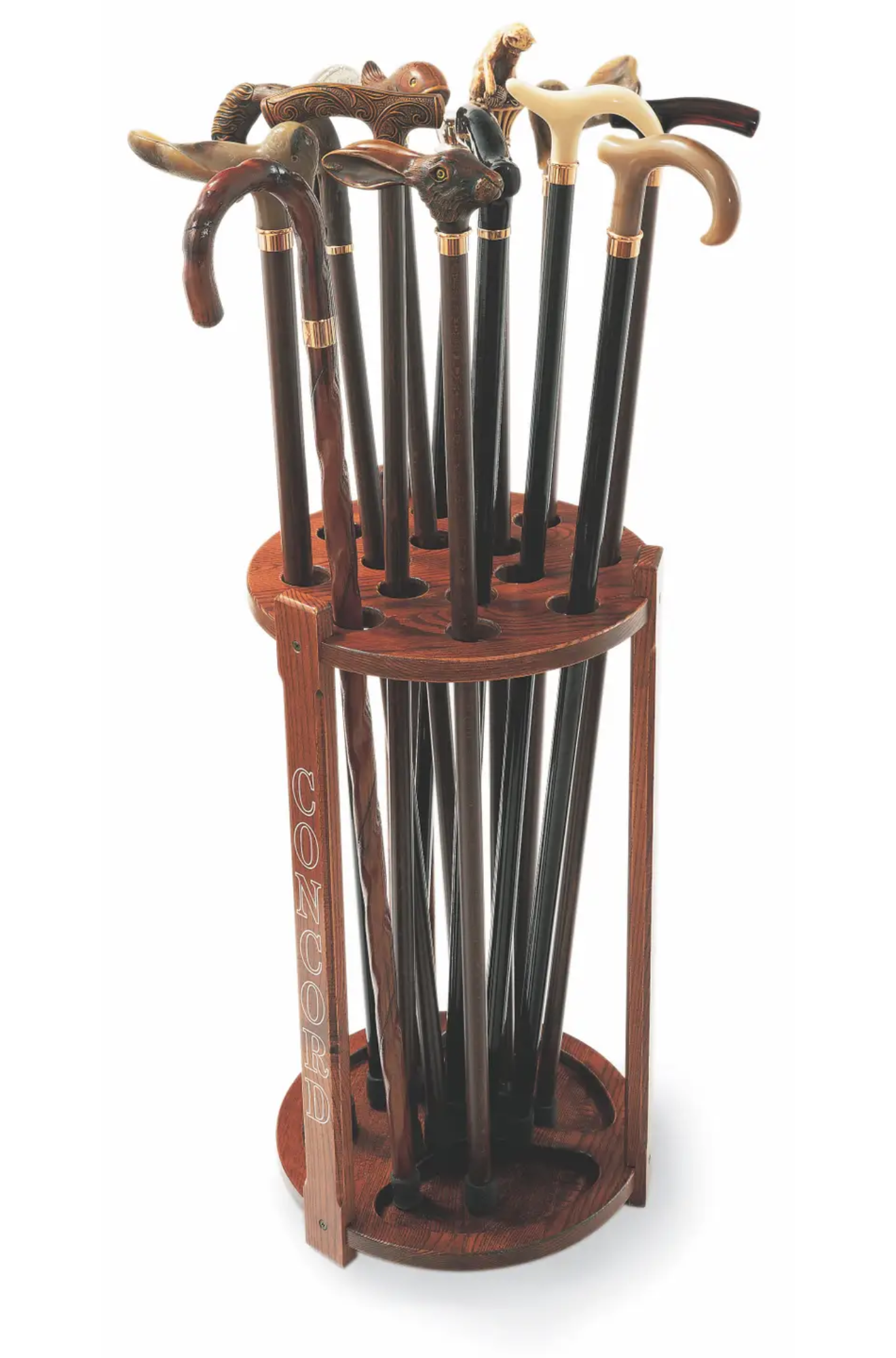 Wooden cane stand holding various walking sticks on a white background